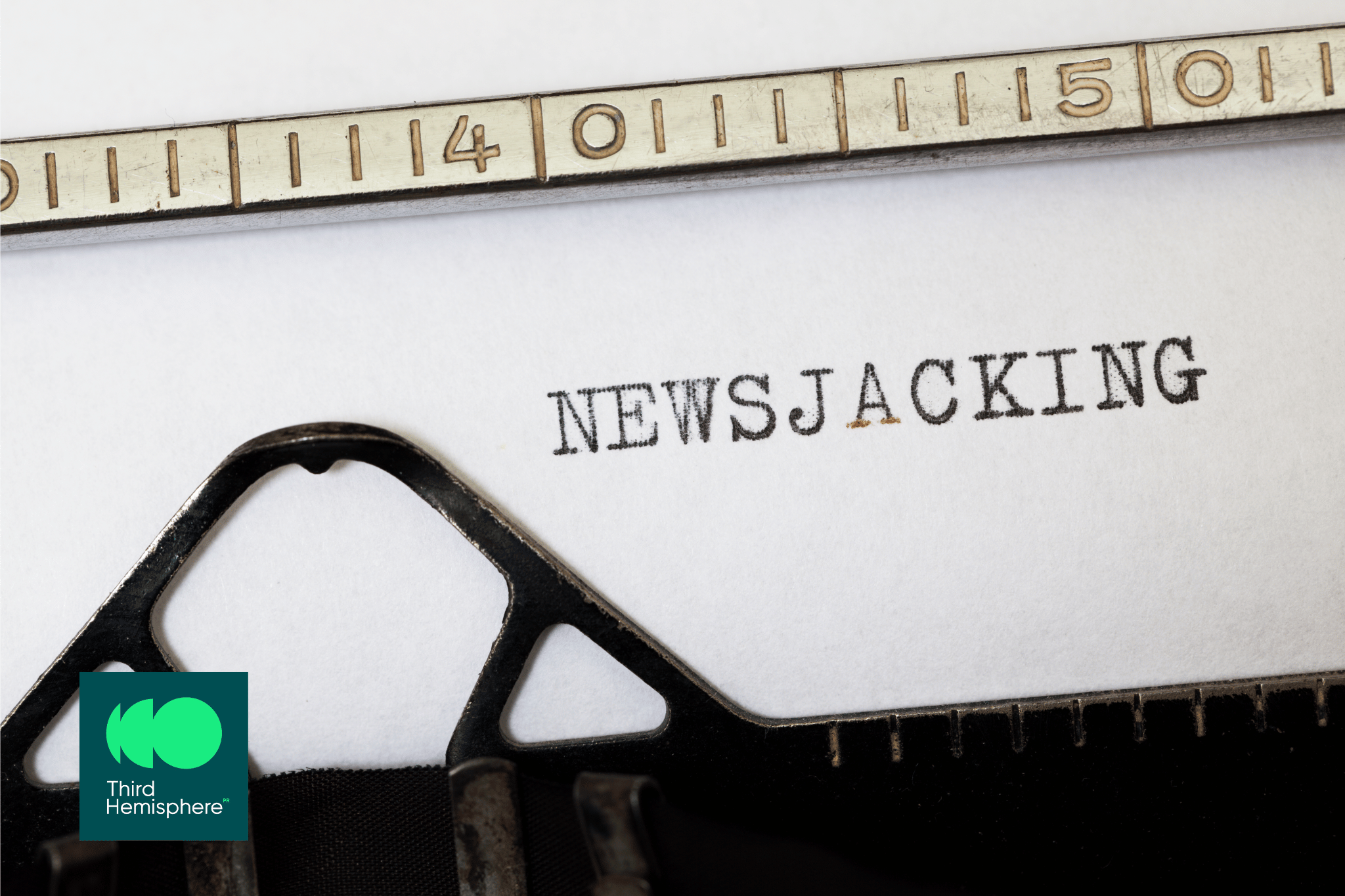 Text "newsjacking" typed on a vintage typewriter, representing the concept of integrating news stories into brand messaging.