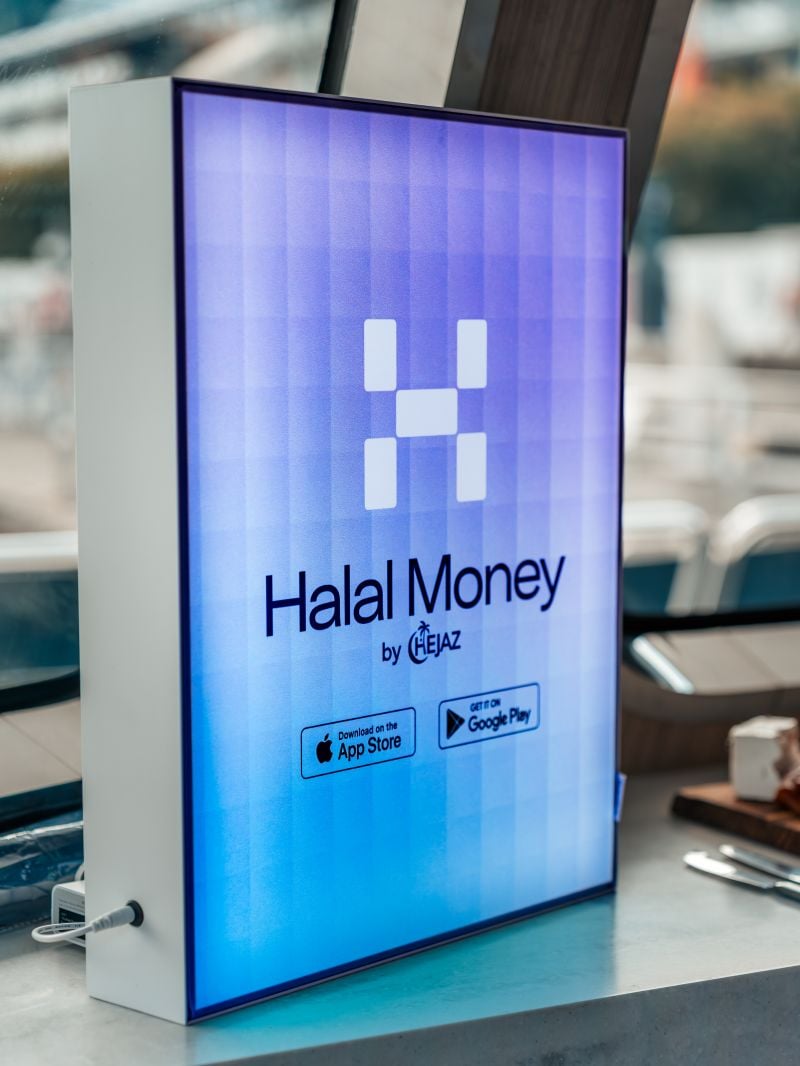 A smartphone displaying the Halal Money app interface, showcasing Shariah-compliant financial services.